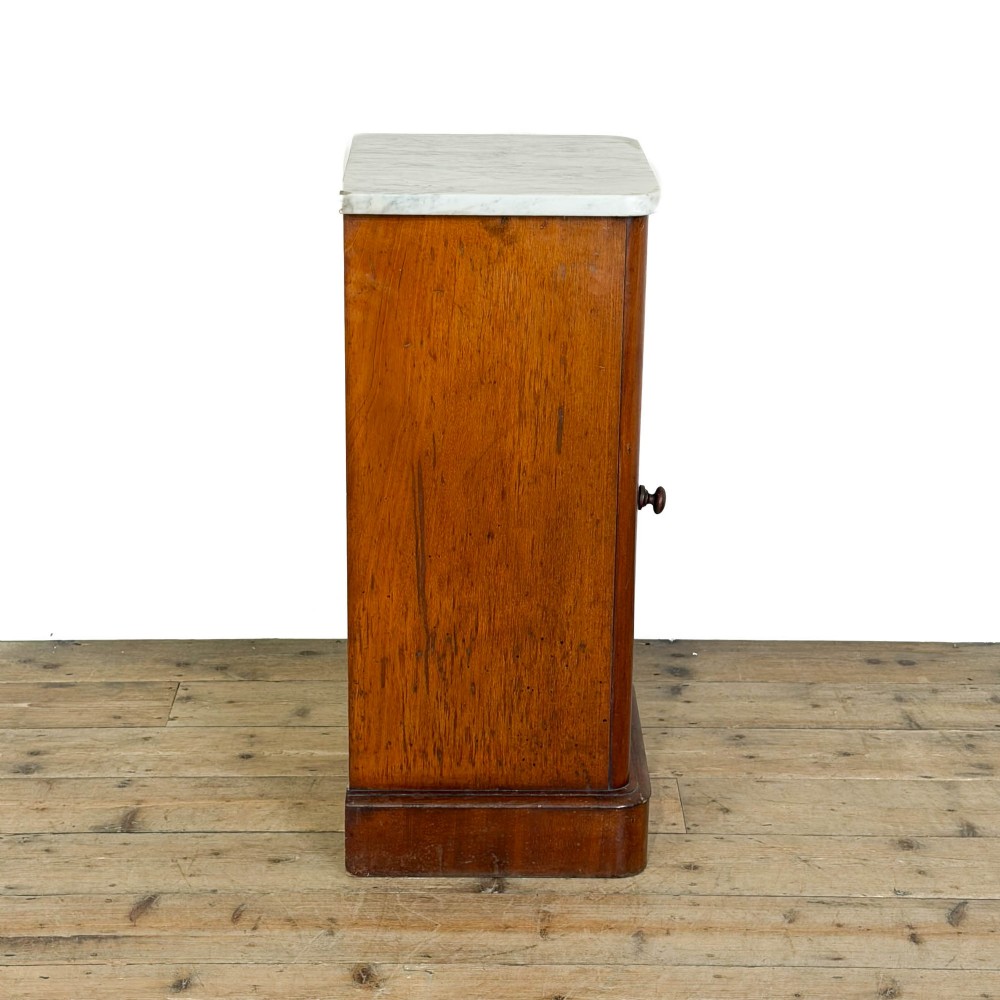 A Victorian mahogany pot cupboard featuring a single panelled door with a turned handle and a white marble top. View VIII