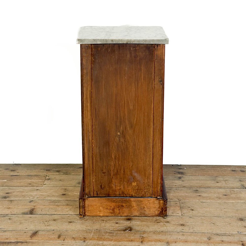 A Victorian mahogany pot cupboard featuring a single panelled door with a turned handle and a white marble top. View IX