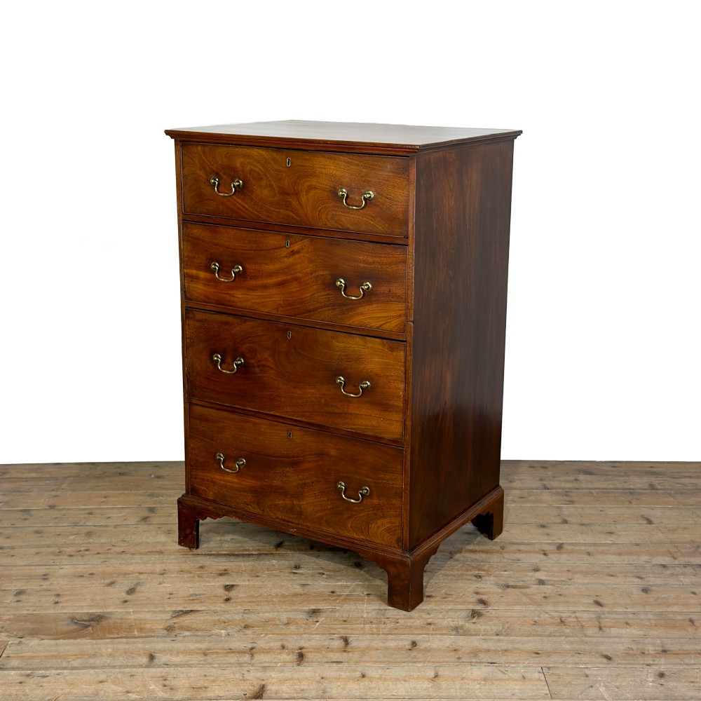 A four-drawer Georgian chest of drawers crafted from dark mahogany wood featuring brass swan-neck handles and bracket feet.