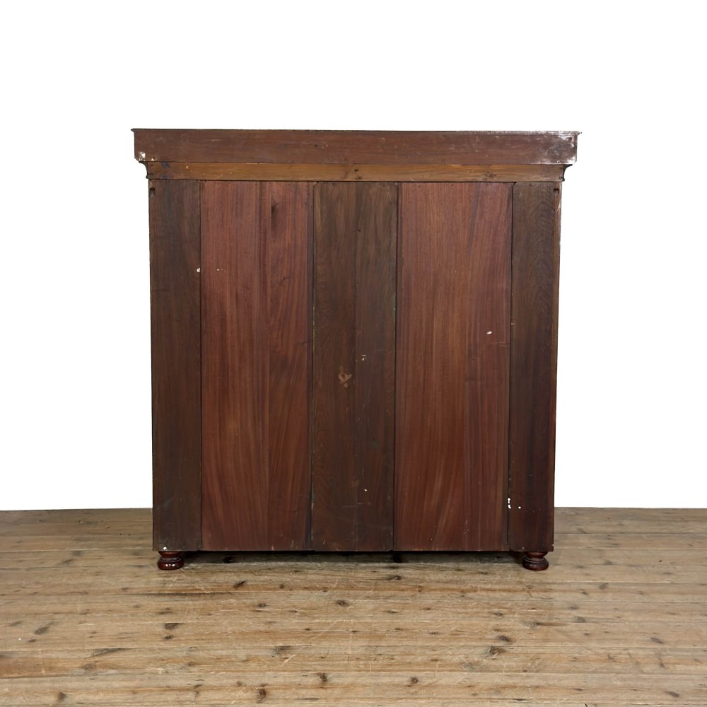 An Edwardian mahogany cabinet featuring an eight-pane glazed door on the left beside a vertical bank of six drawers with brass handles. View II