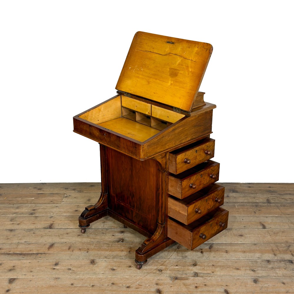 An antique Victorian walnut Davenport desk featuring a slanted leather-lined writing surface, an upper stationery compartment, and four drawers on the side. View III