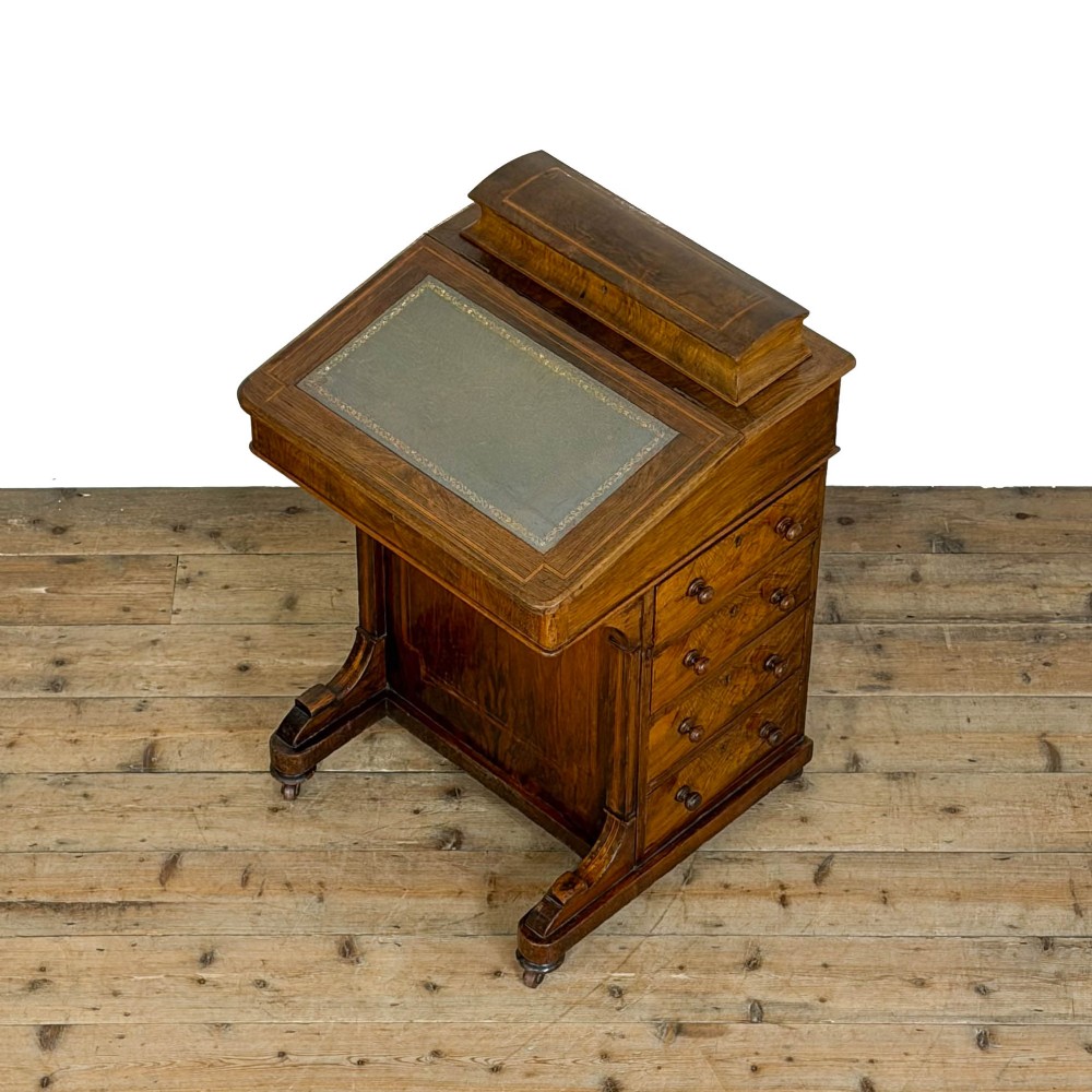 An antique Victorian walnut Davenport desk featuring a slanted leather-lined writing surface, an upper stationery compartment, and four drawers on the side. View VI