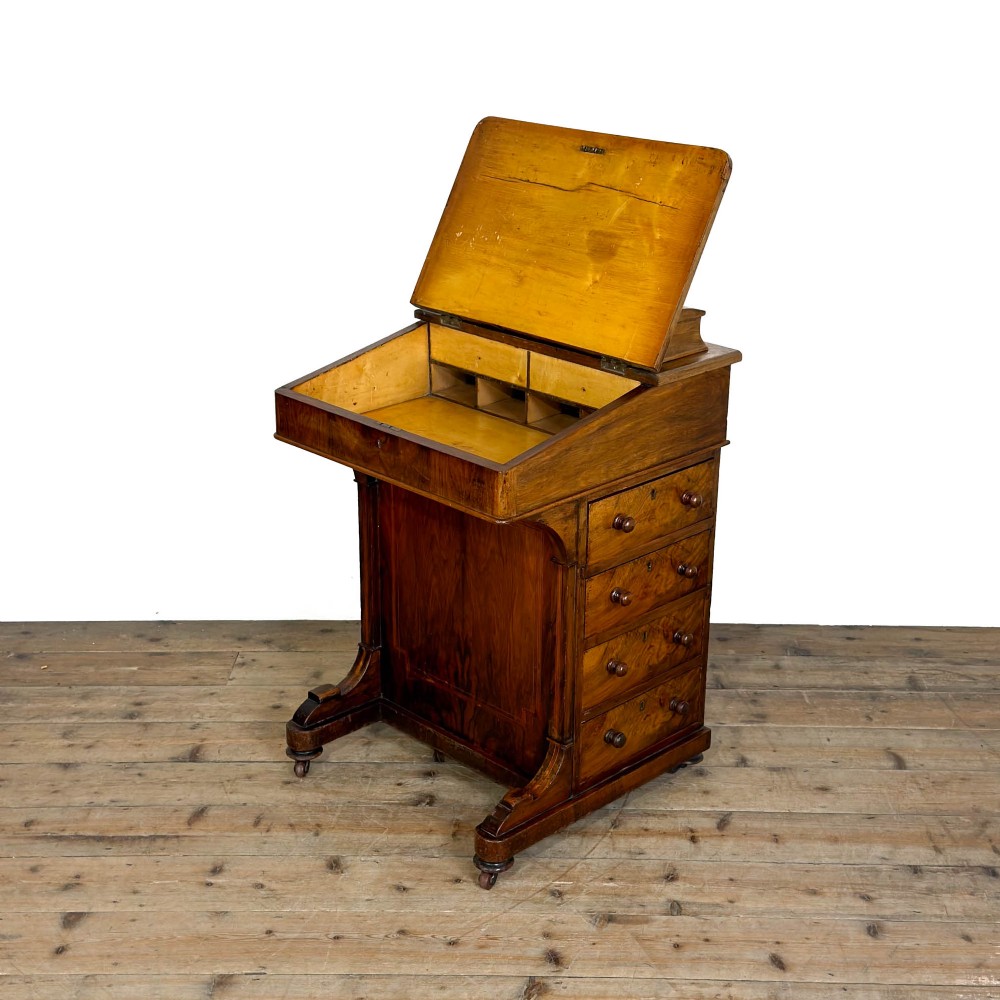 An antique Victorian walnut Davenport desk featuring a slanted leather-lined writing surface, an upper stationery compartment, and four drawers on the side. View VII
