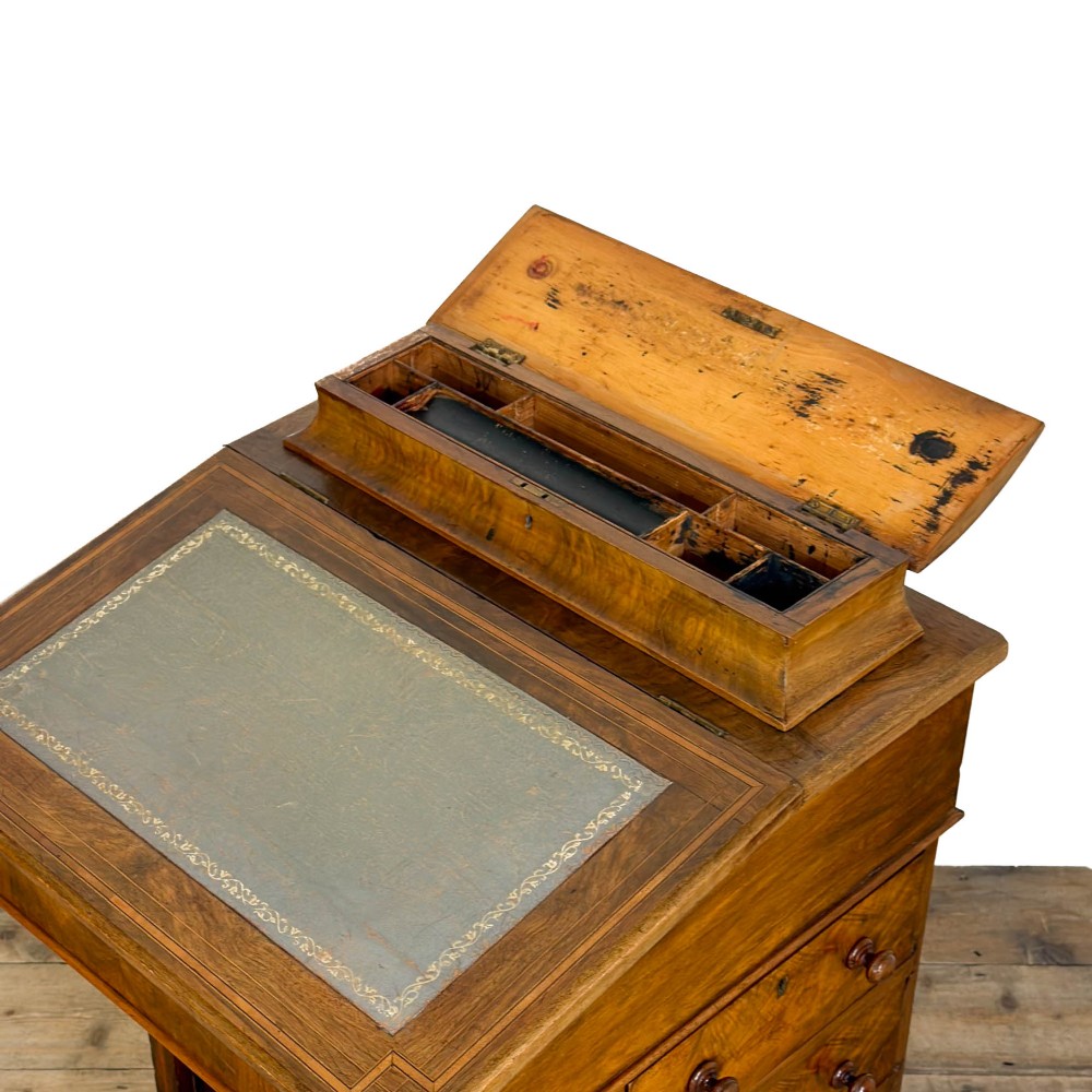 An antique Victorian walnut Davenport desk featuring a slanted leather-lined writing surface, an upper stationery compartment, and four drawers on the side. View VIII