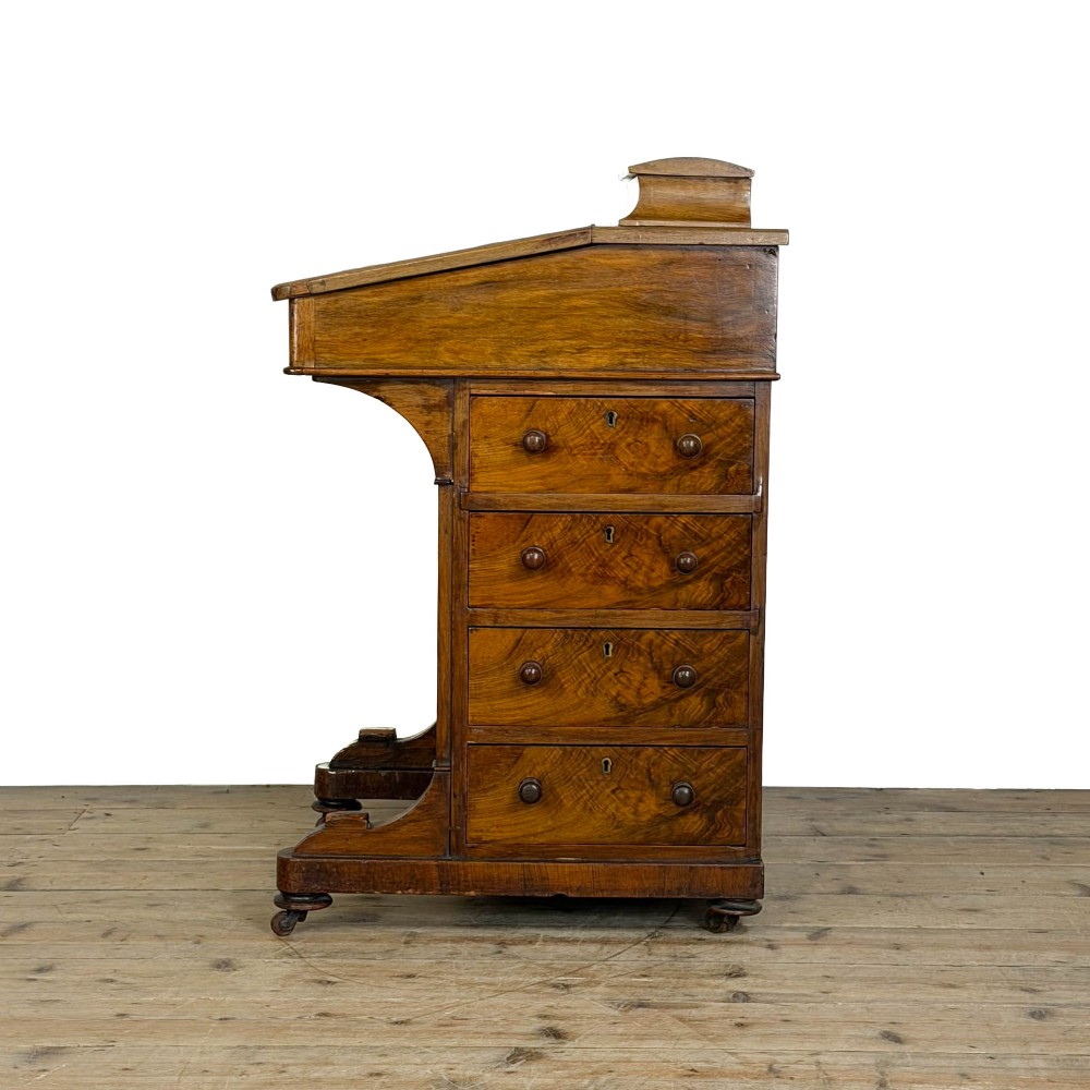 An antique Victorian walnut Davenport desk featuring a slanted leather-lined writing surface, an upper stationery compartment, and four drawers on the side. View IX