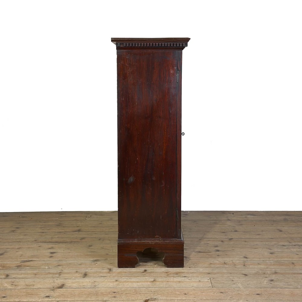 A 19th-century dark mahogany low bookcase featuring two glazed doors with geometric astragal glazing bars, dentil moulding at the top cornice, and bracket feet. View III