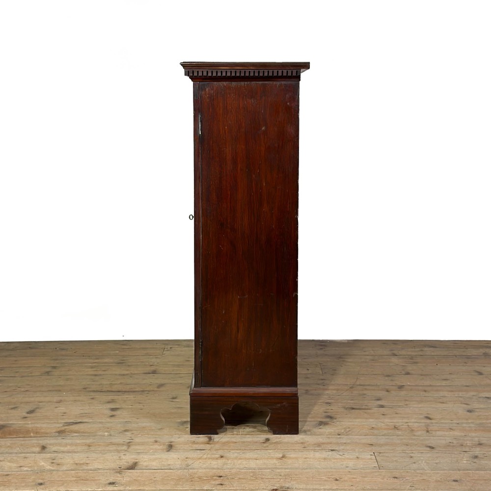 A 19th-century dark mahogany low bookcase featuring two glazed doors with geometric astragal glazing bars, dentil moulding at the top cornice, and bracket feet. View VII