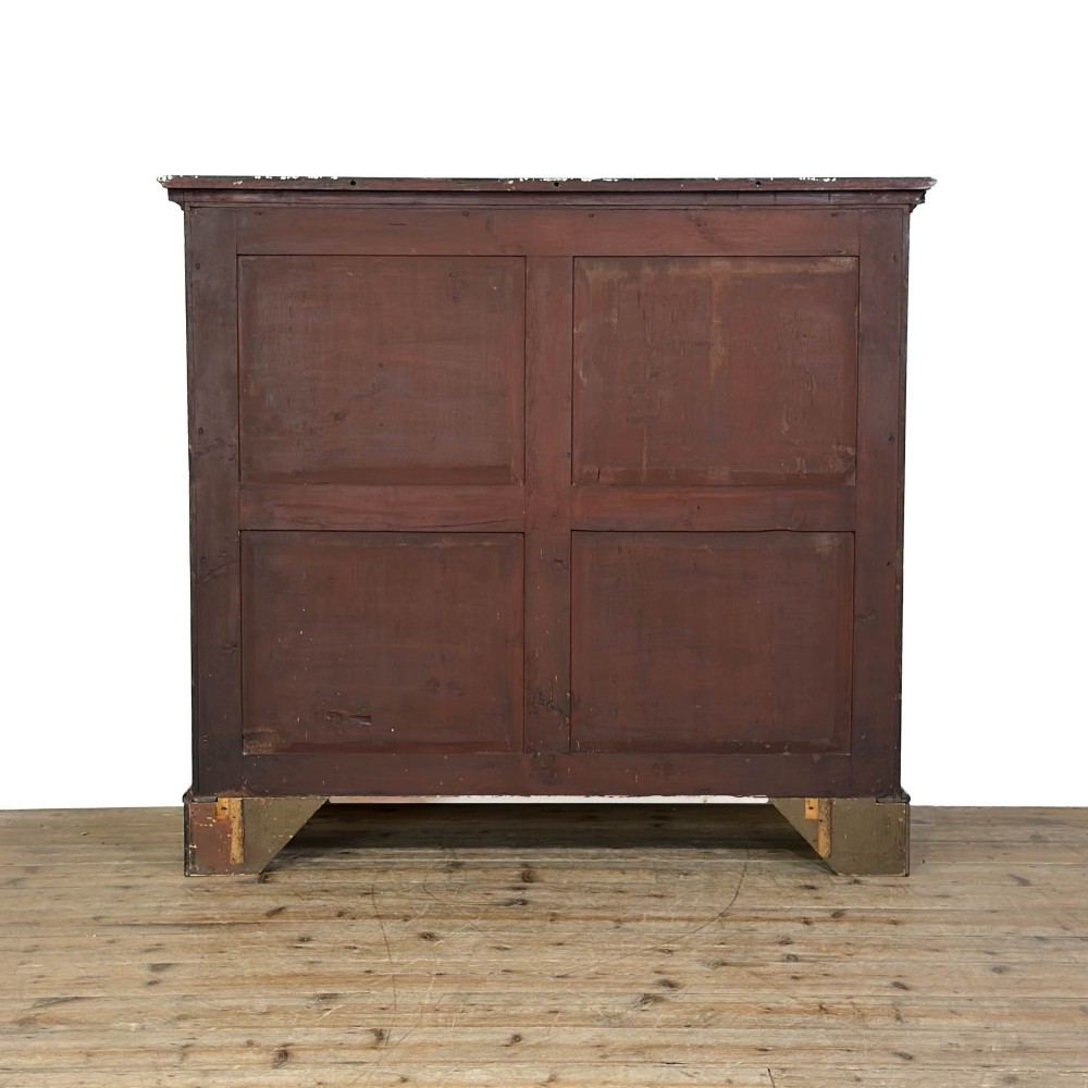 A 19th-century dark mahogany low bookcase featuring two glazed doors with geometric astragal glazing bars, dentil moulding at the top cornice, and bracket feet. View VIII