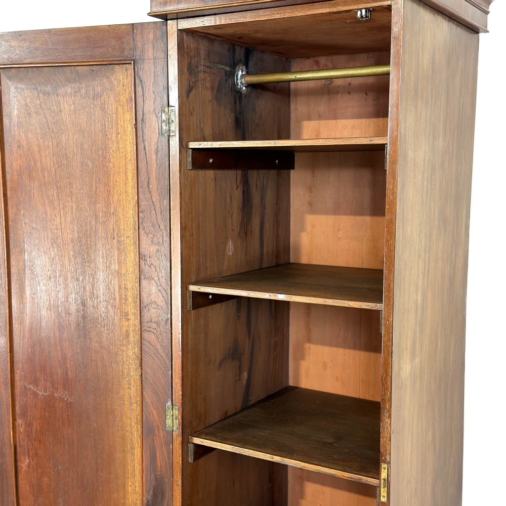 A tall single door mahogany wardrobe featuring a moulded cornice, flame mahogany veneer door panel, and bracket feet. View IV