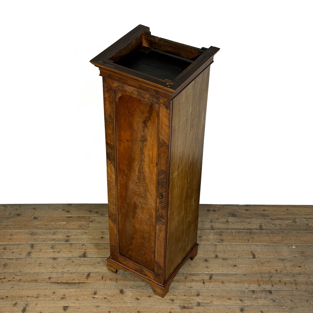 A tall single door mahogany wardrobe featuring a moulded cornice, flame mahogany veneer door panel, and bracket feet. View V