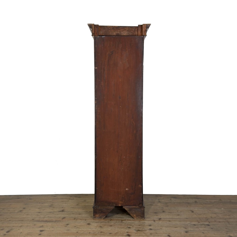 A tall single door mahogany wardrobe featuring a moulded cornice, flame mahogany veneer door panel, and bracket feet. View VI