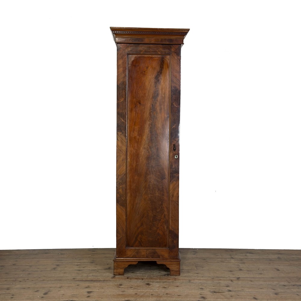 A tall single door mahogany wardrobe featuring a moulded cornice, flame mahogany veneer door panel, and bracket feet. View VIII