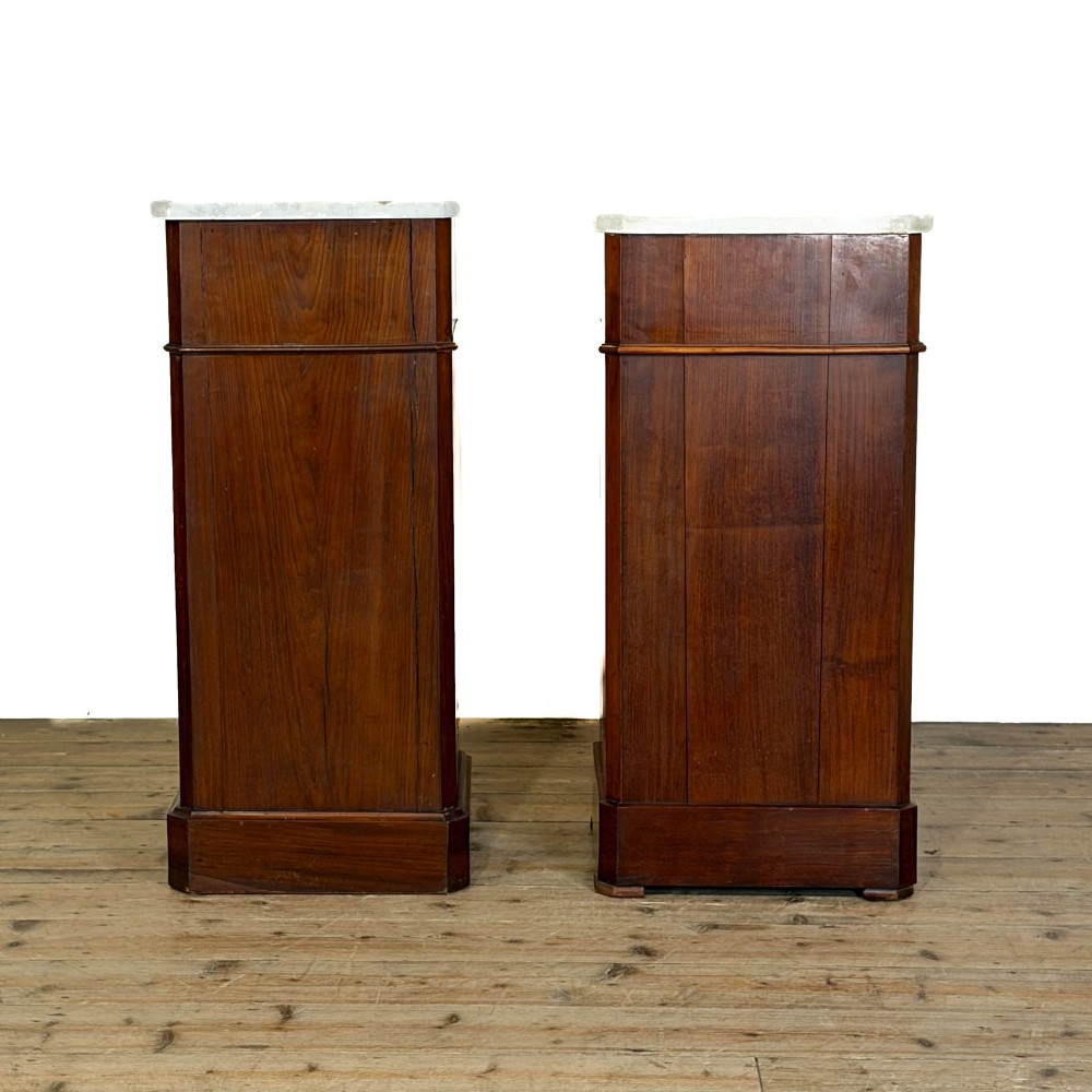 A matching pair of French Louis Philippe style walnut bedside cabinets with white marble tops, upper drawers, lower cupboard doors, and plinth bases. View VII