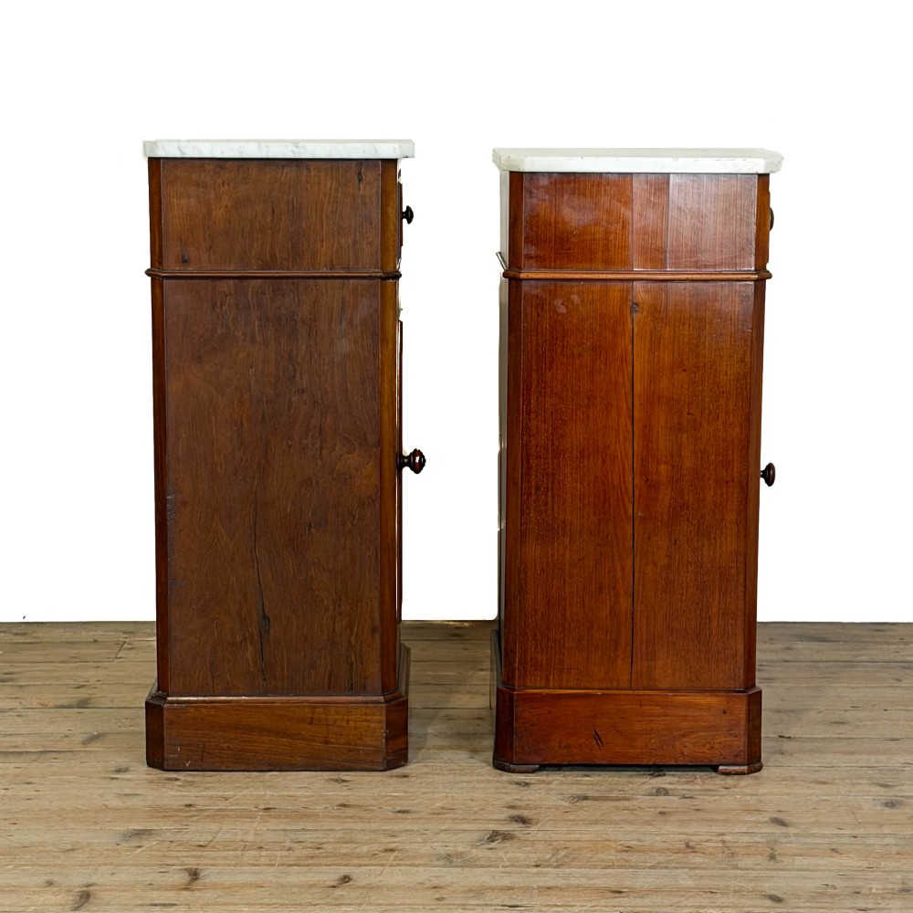 A matching pair of French Louis Philippe style walnut bedside cabinets with white marble tops, upper drawers, lower cupboard doors, and plinth bases. View VIII