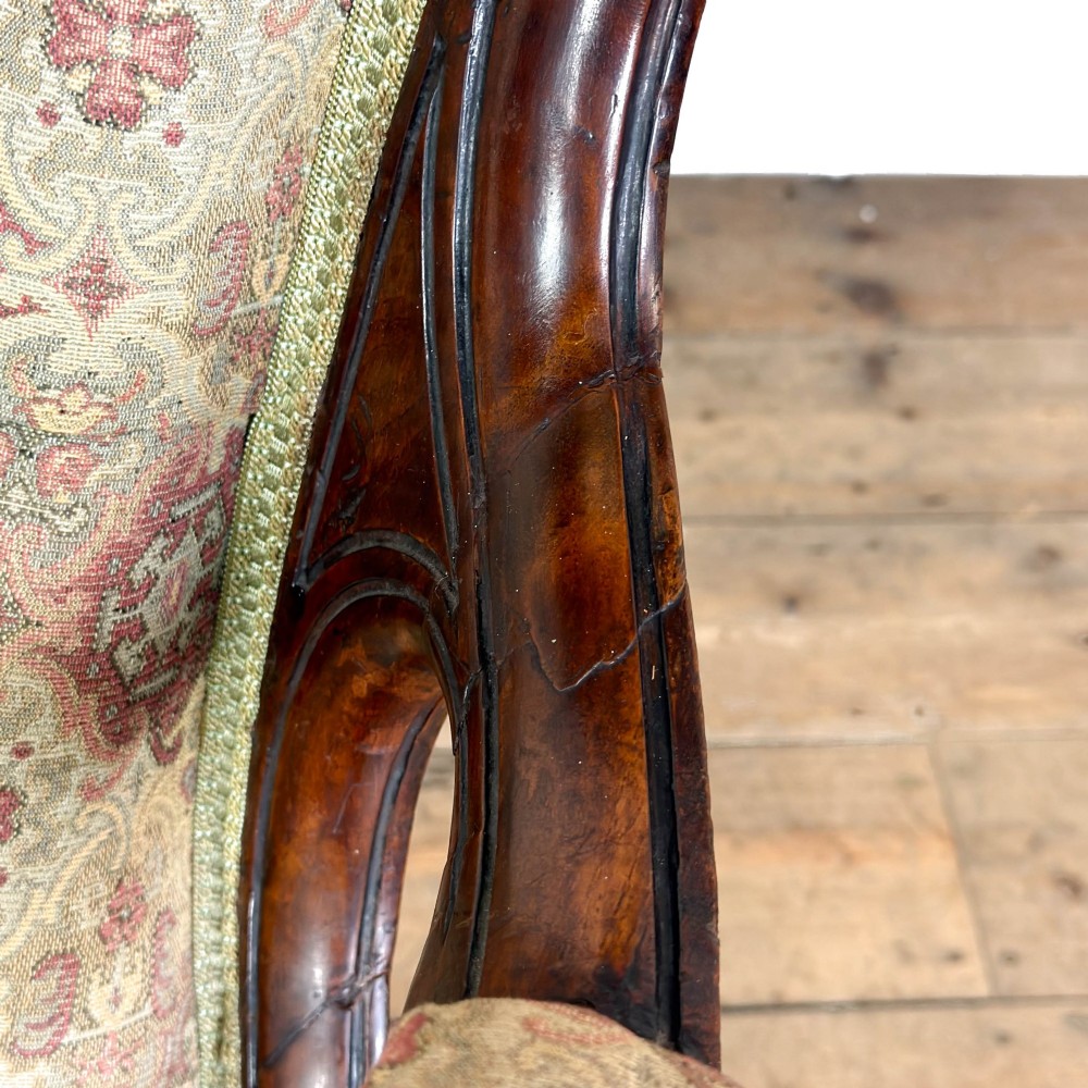 Victorian carved mahogany armchair with deep button-backed floral tapestry upholstery, curved armrests, and cabriole legs on brass castors. View VII