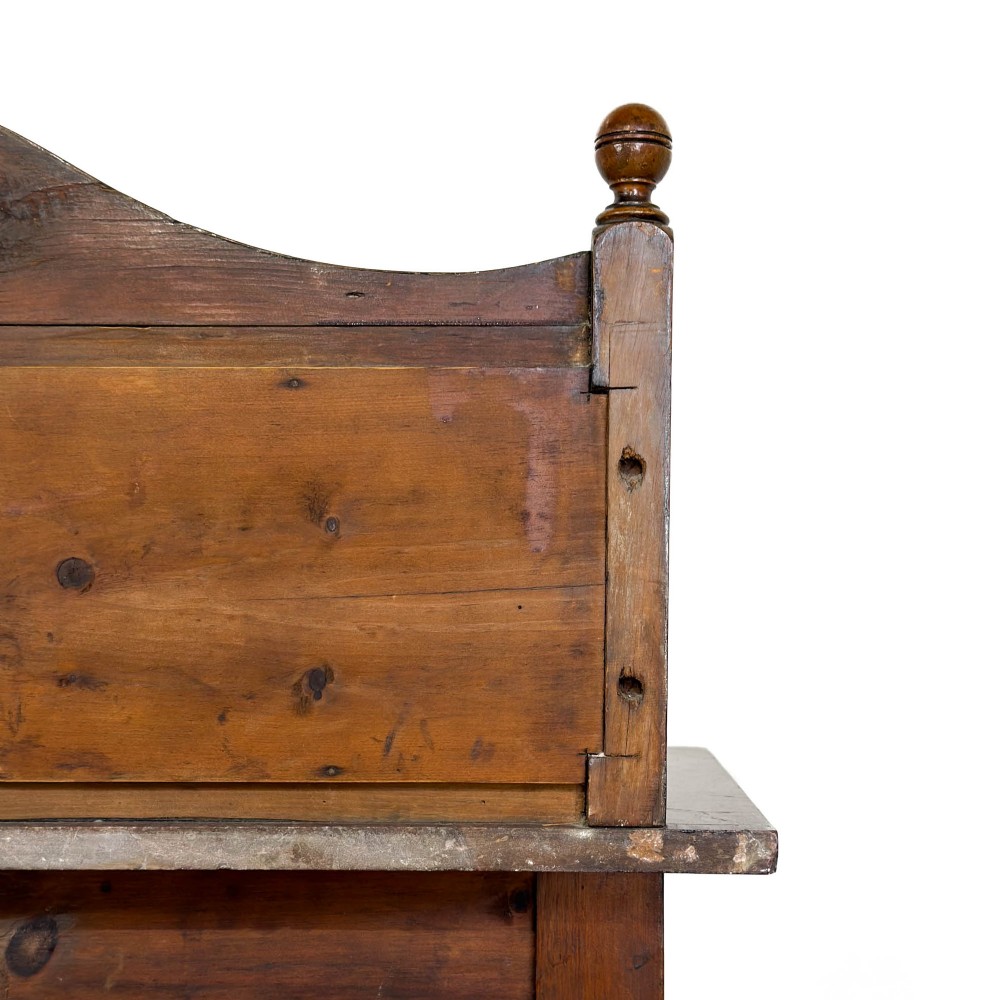 An Edwardian wooden washstand with a carved splashback housing floral glazed tiles, a single drawer with drop handles, turned legs, and an undertier shelf. View IX