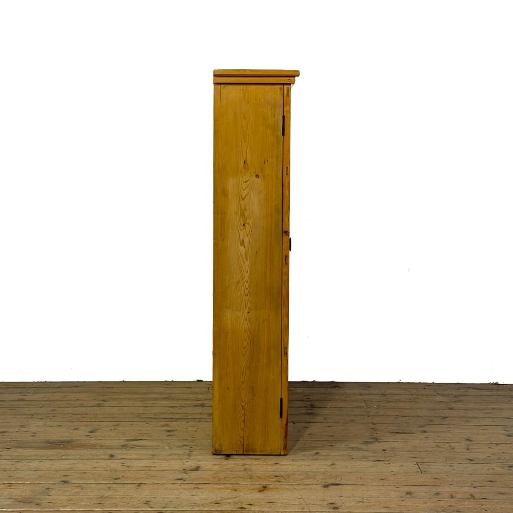 A large vintage pine cabinet featuring twin glazed doors with multiple glass panes and dark wooden knob handles. View II