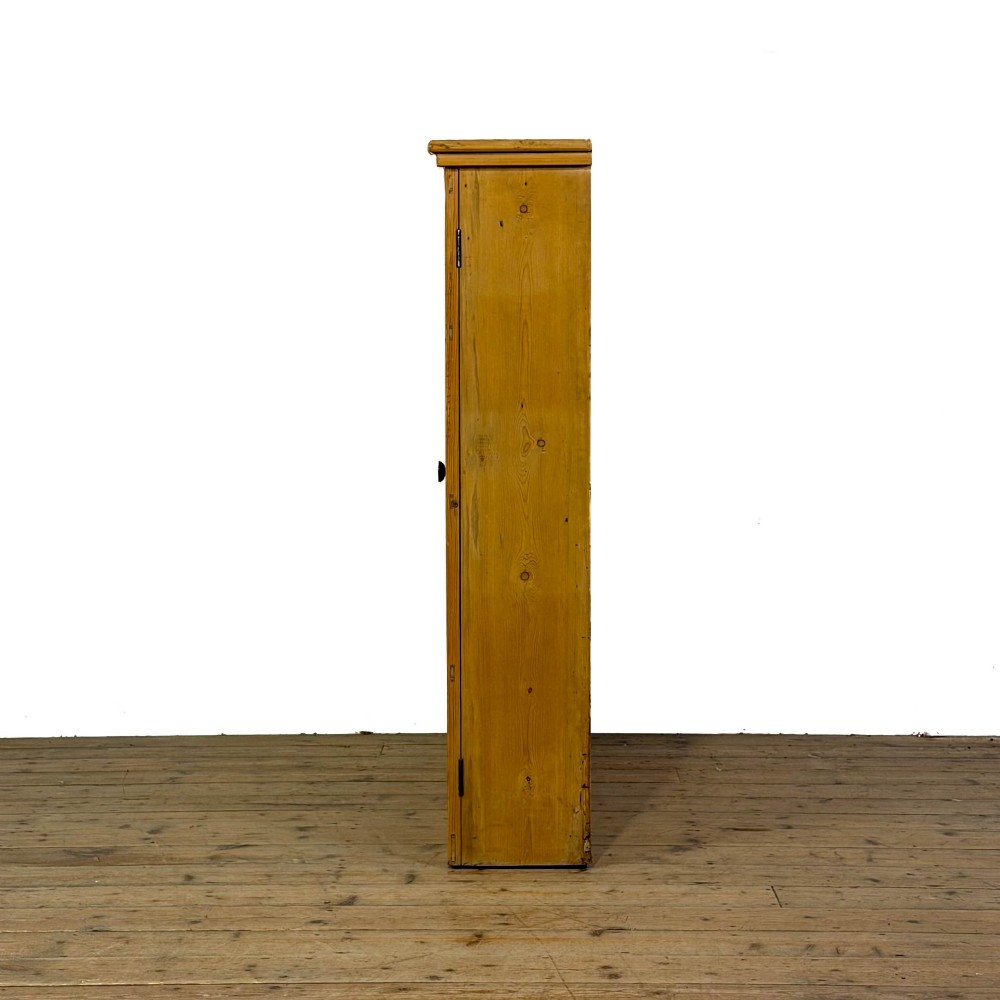 A large vintage pine cabinet featuring twin glazed doors with multiple glass panes and dark wooden knob handles. View VII