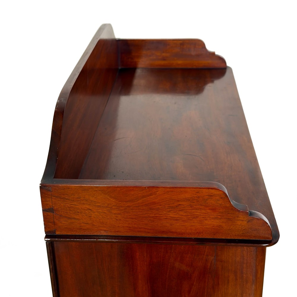 A small antique open mahogany bookcase featuring four tiers of shelving and a galleried top upstand. View III