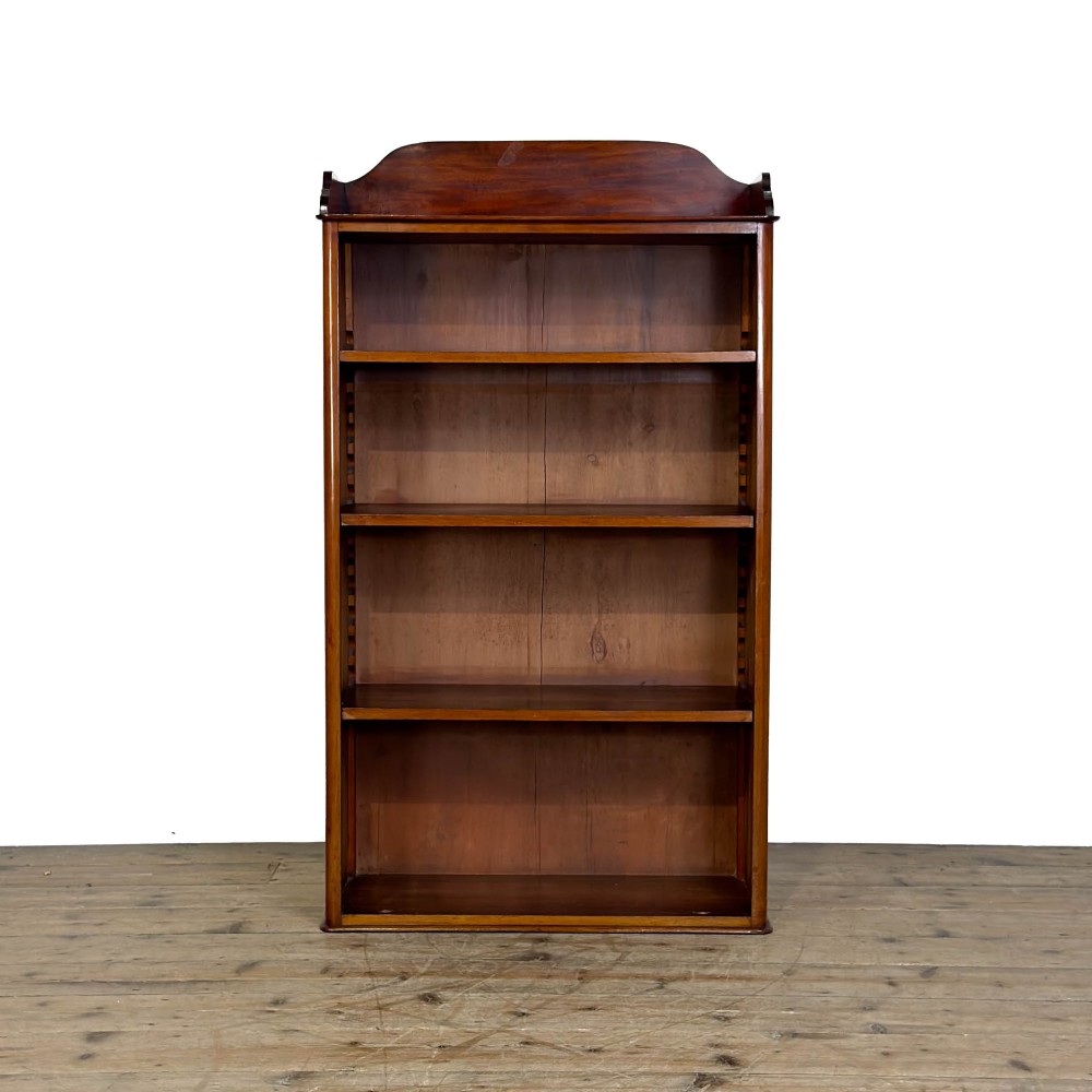 A small antique open mahogany bookcase featuring four tiers of shelving and a galleried top upstand. View V