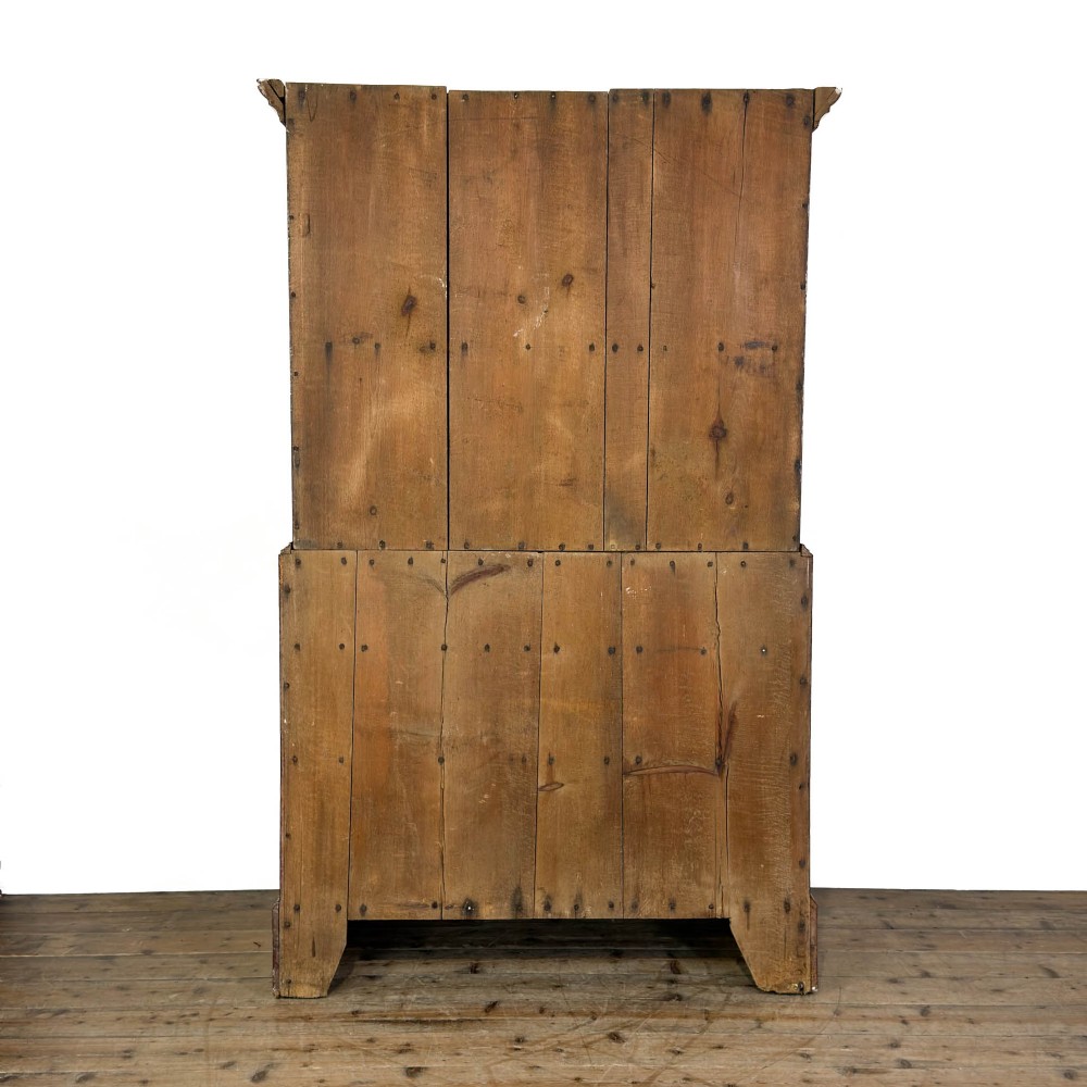 A tall Victorian painted pine housekeepers cupboard in a terracotta red finish, featuring a double-door upper cabinet over two short and two long drawers. View XI