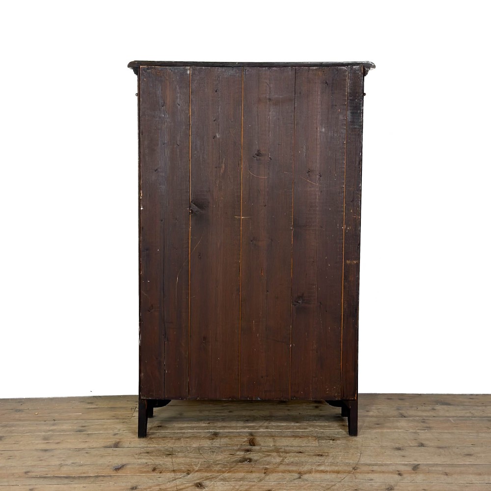 An open antique oak bookcase featuring four wooden shelves, a upper moulded cornice, vertical pine backboards, and shaped bracket feet. View X