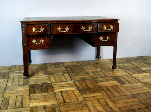 A Good Mahogany Serpentine Leather Top Edwardian Desk
