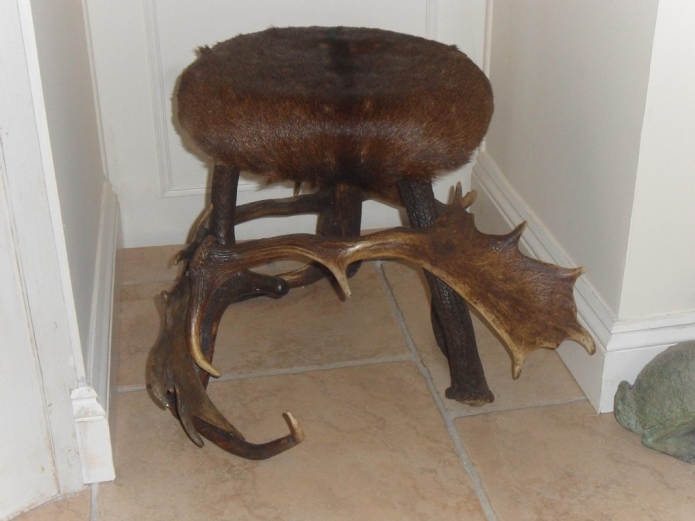 ANTLER STOOL WITH HIDE COVERING TO SEAT