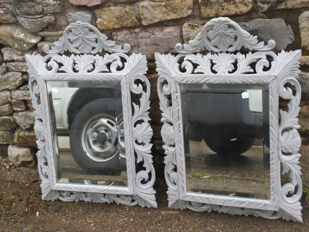 Pair of carved oak mirrors