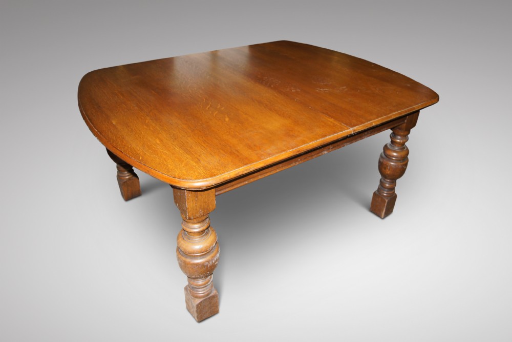 A substantial Oak wind out table