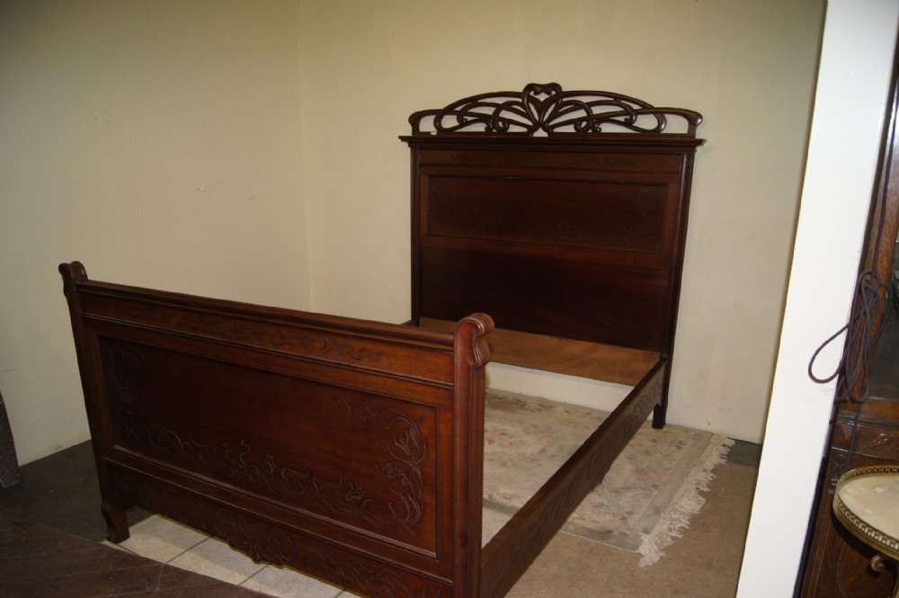 A Marjorelle style art nouveau walnut double bed