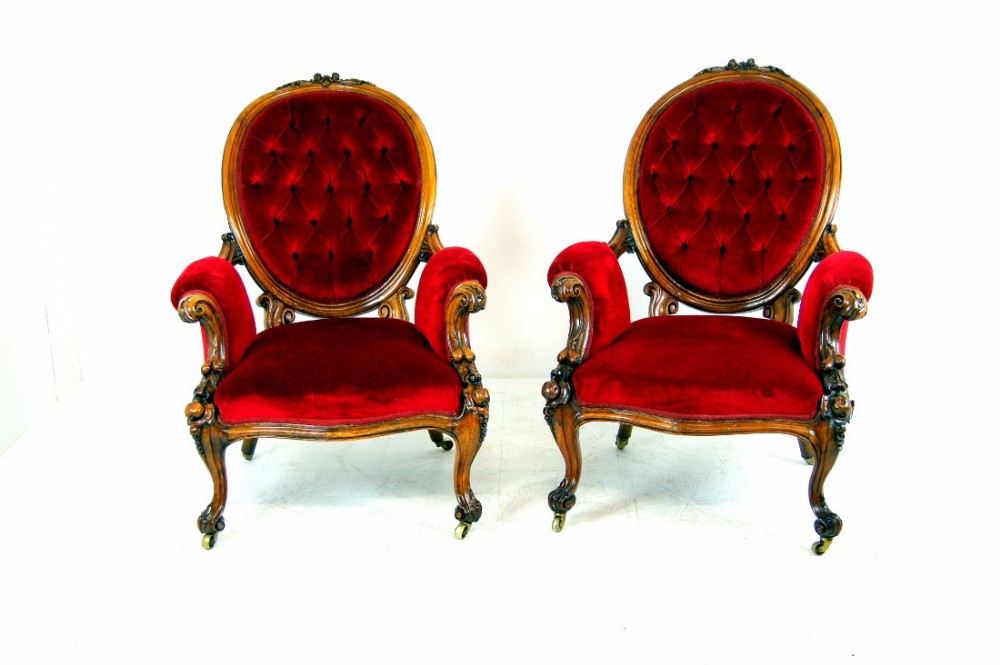 An outstanding pair of open armed Victorian, walnut gentleman's chairs