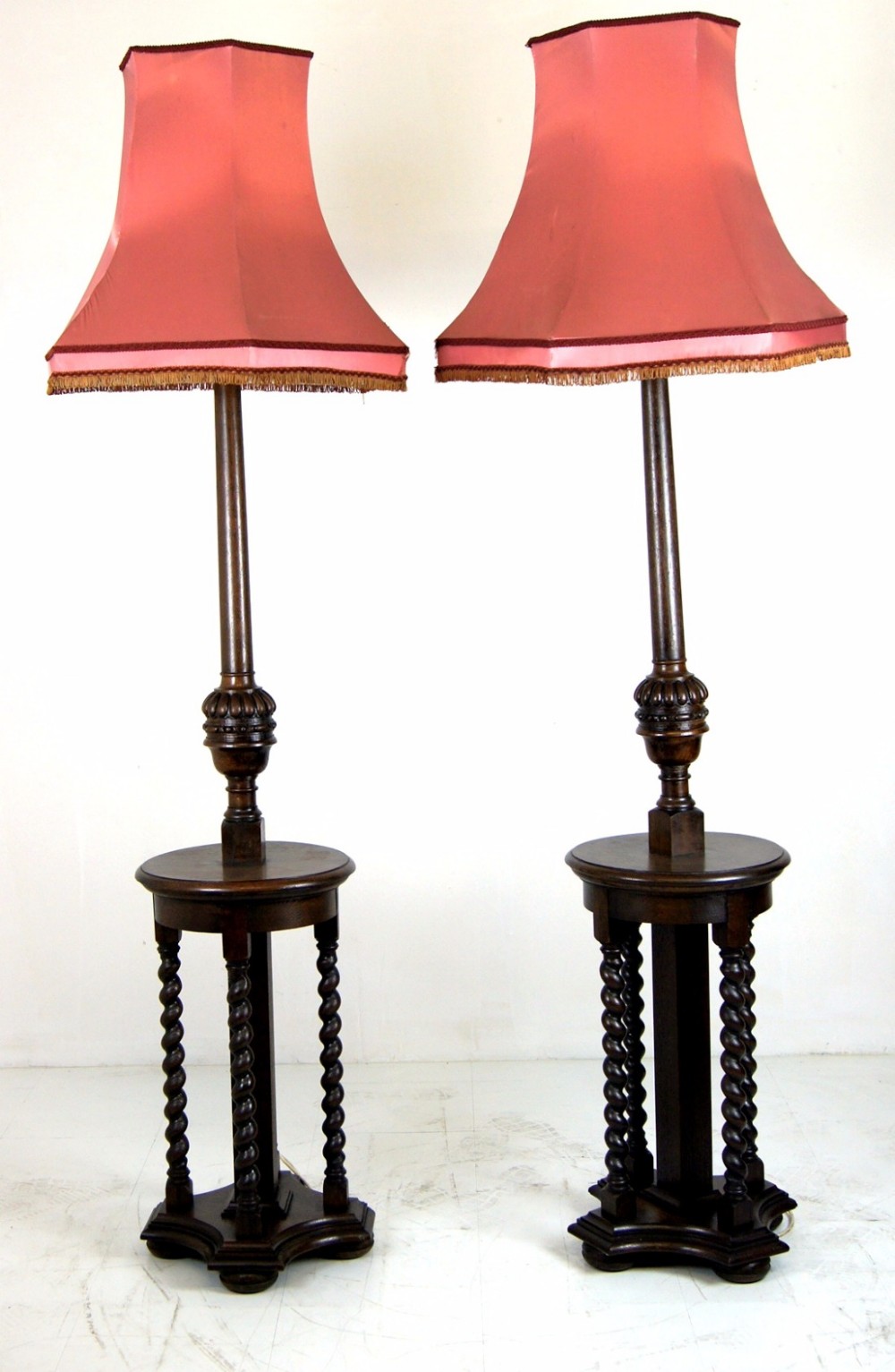 A matched pair of solid oak electric lamp standards