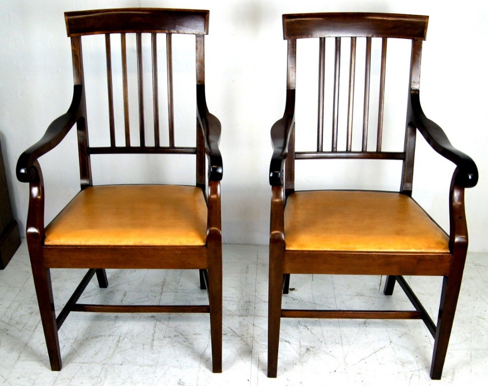 A substantial pair of Georgian style inlaid mahogany arm chairs 