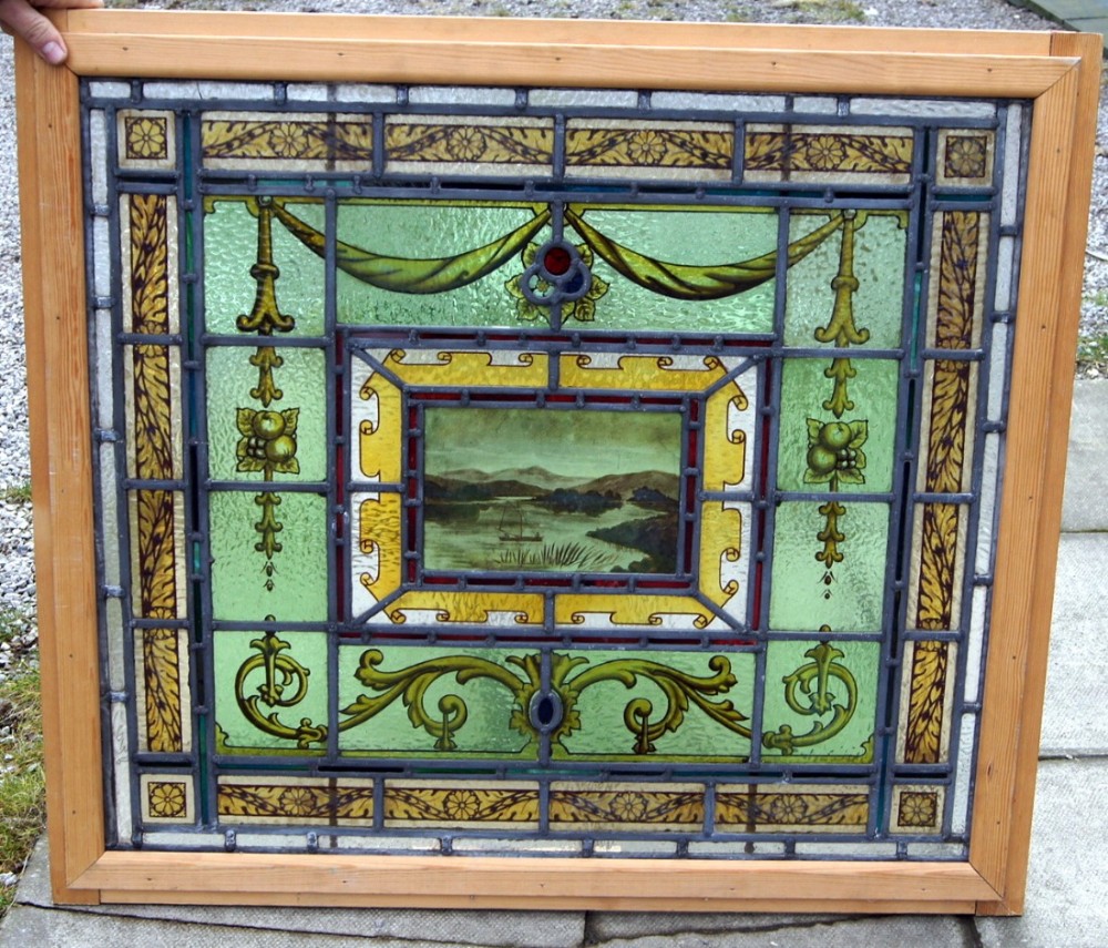 A lovely painted window depicting a lakeland scene