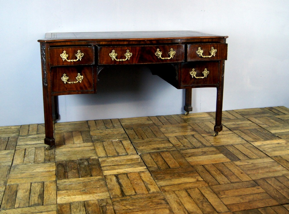 A good mahogany serpentine leather top Edwardian desk