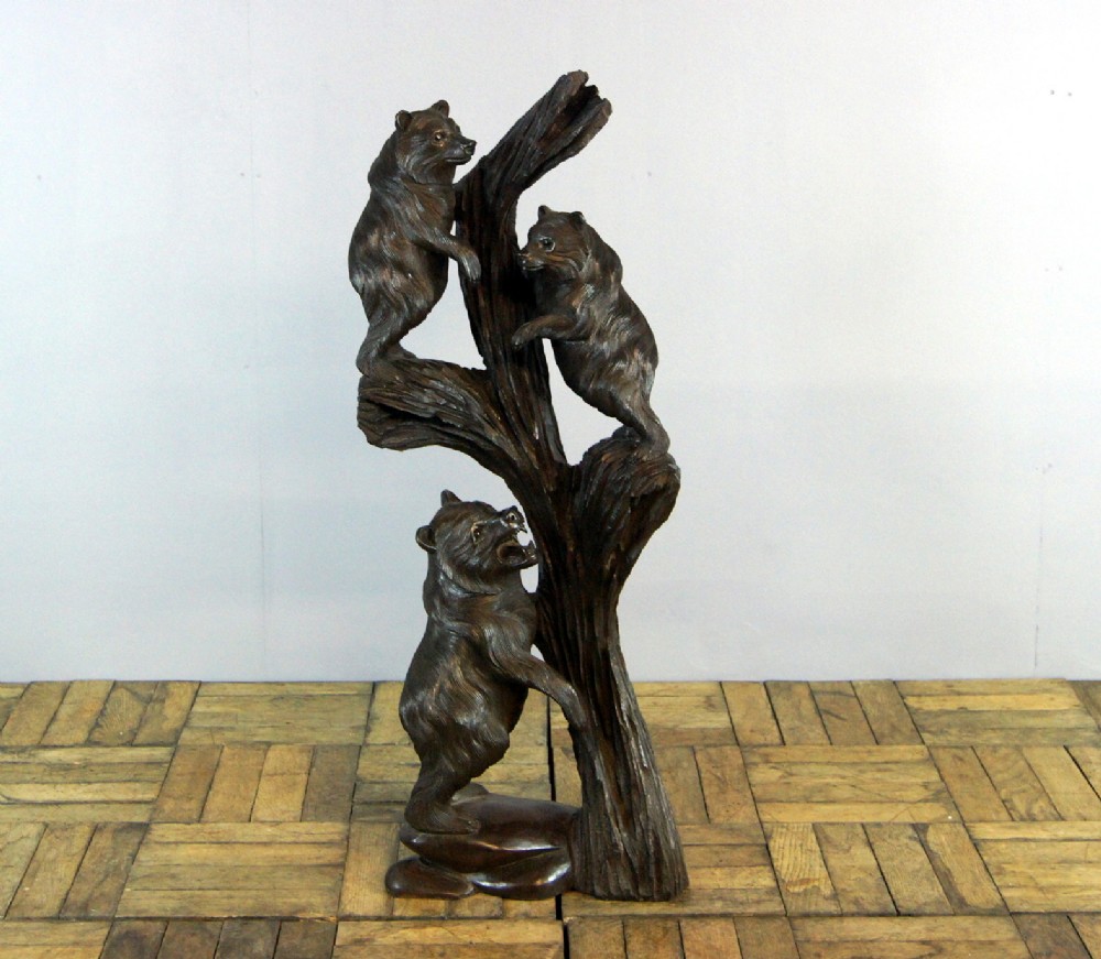 A very rare blackforrest carving of 3 bear cubs on a tree branch