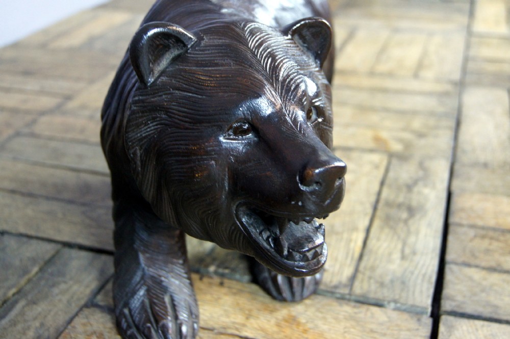A charming carved free standing black forest bear