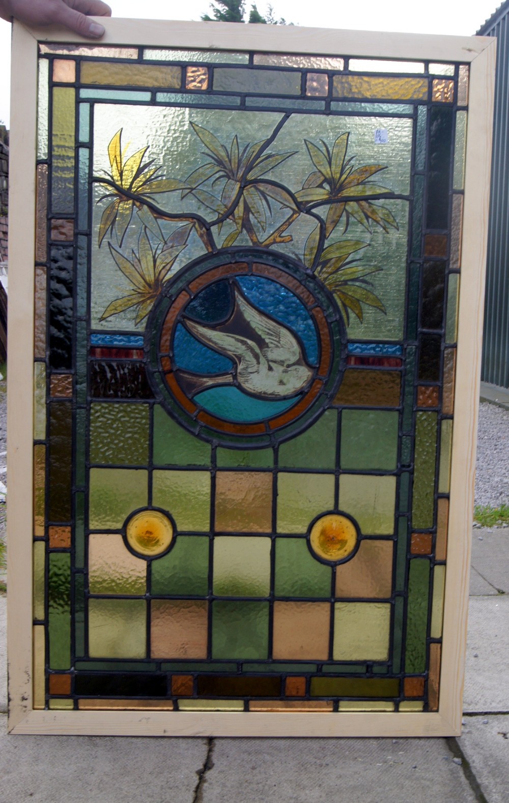 A stunning leaded glass and painted window of a bird in flight
