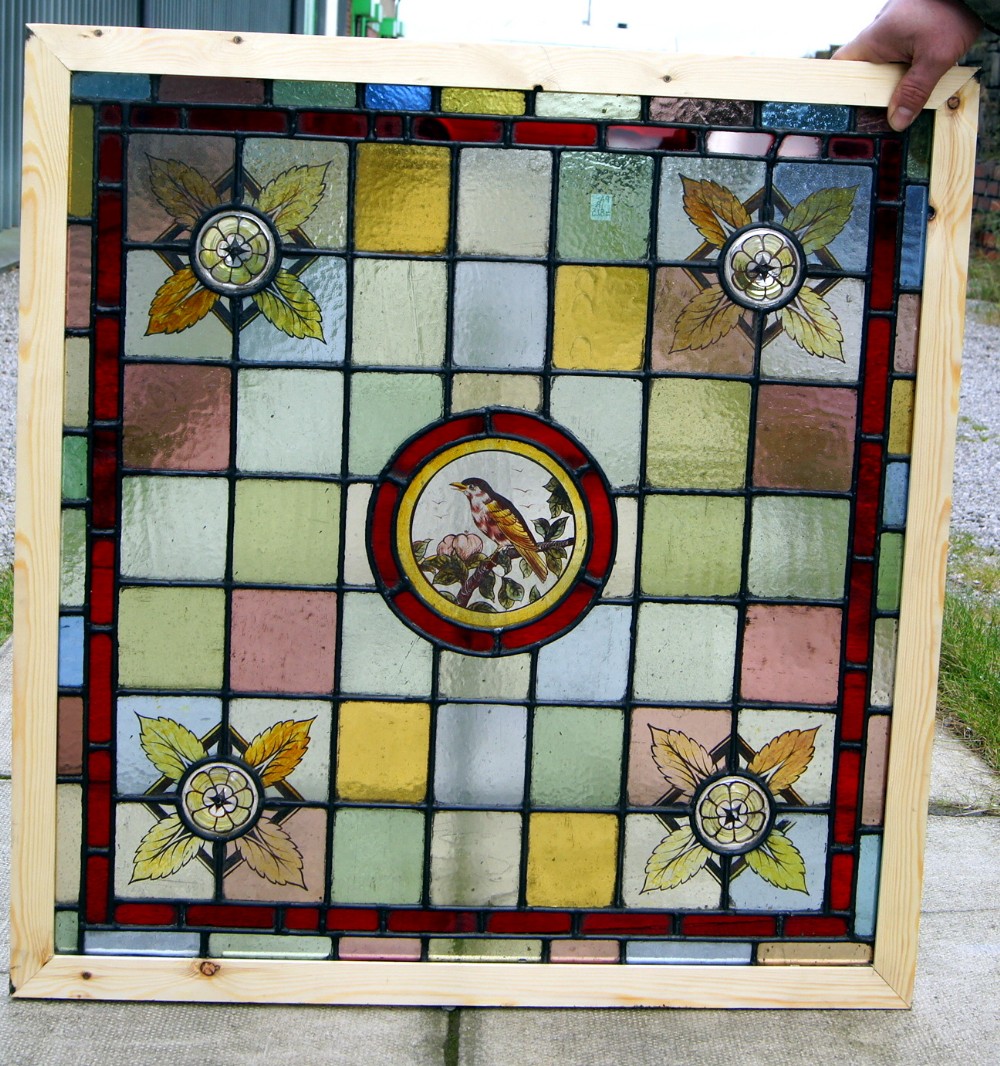 A stunning pair of painted leaded glass bird windows