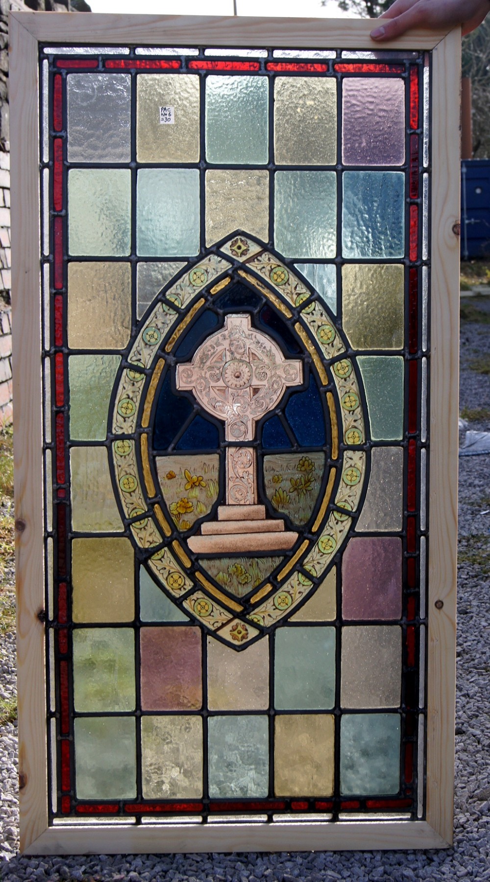 A great painted window of a Celtic style cross