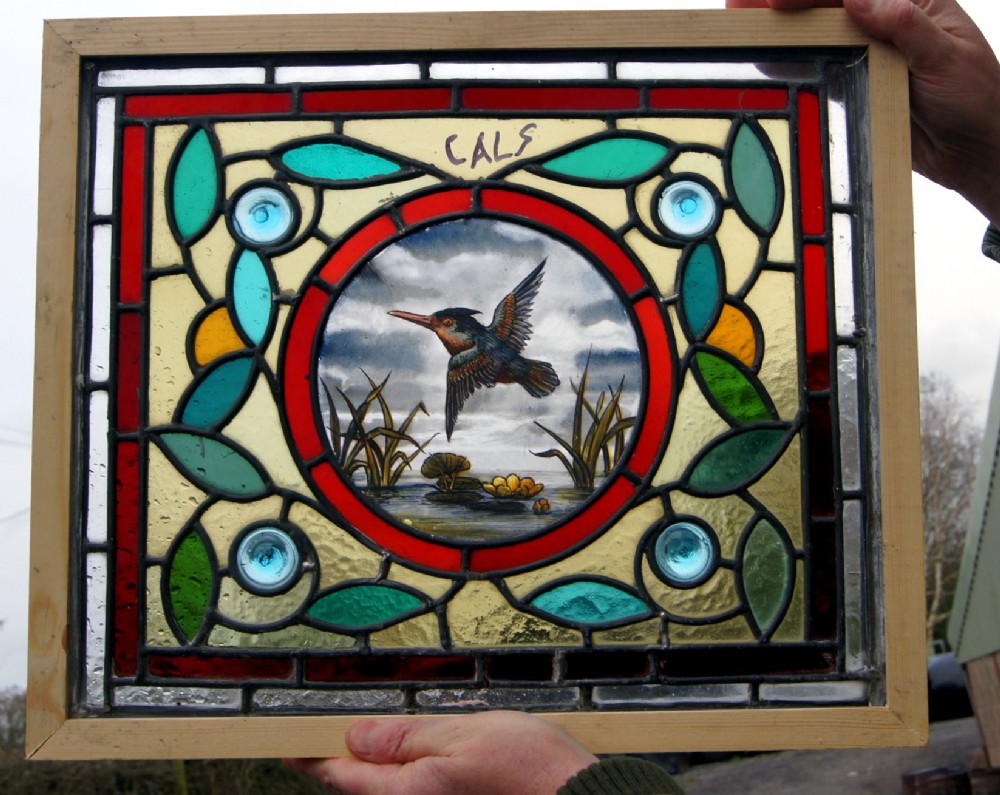 A vibrant stained glass painted bird window 