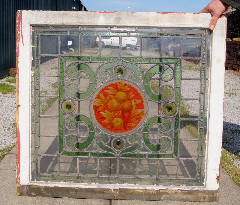 A stunning painted leaded glass fruit window 