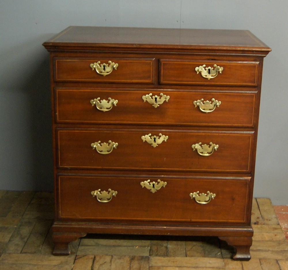A petite George III mahogany inlaid chest of drawers