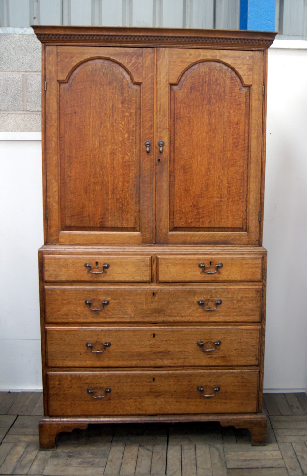 A charming pale oak country cupboard on chest 