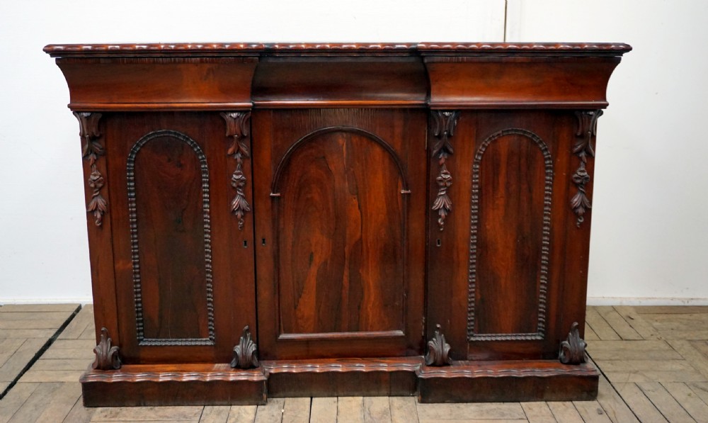 A petite rosewood inverted breakfront chiffonier 