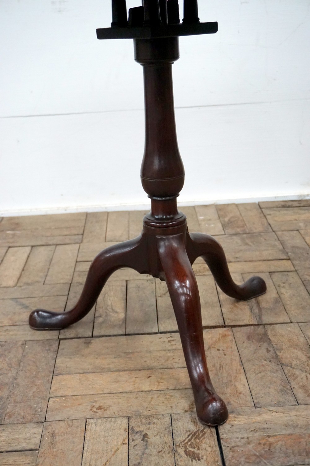 A Georgian mahogany tilt-top table featuring a circular top over a turned central stem and tripod cabriole legs with pad feet. View VIII