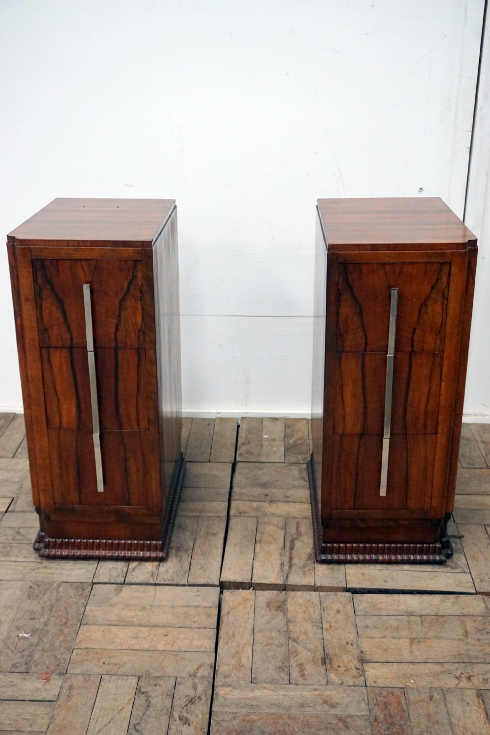 A pair of walnut deco bedside chests