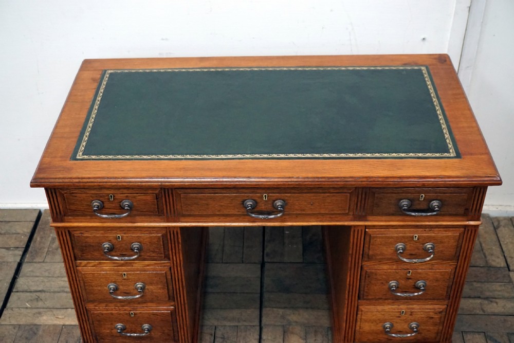 A small clean oak pedastal desk with 9 drawers View II