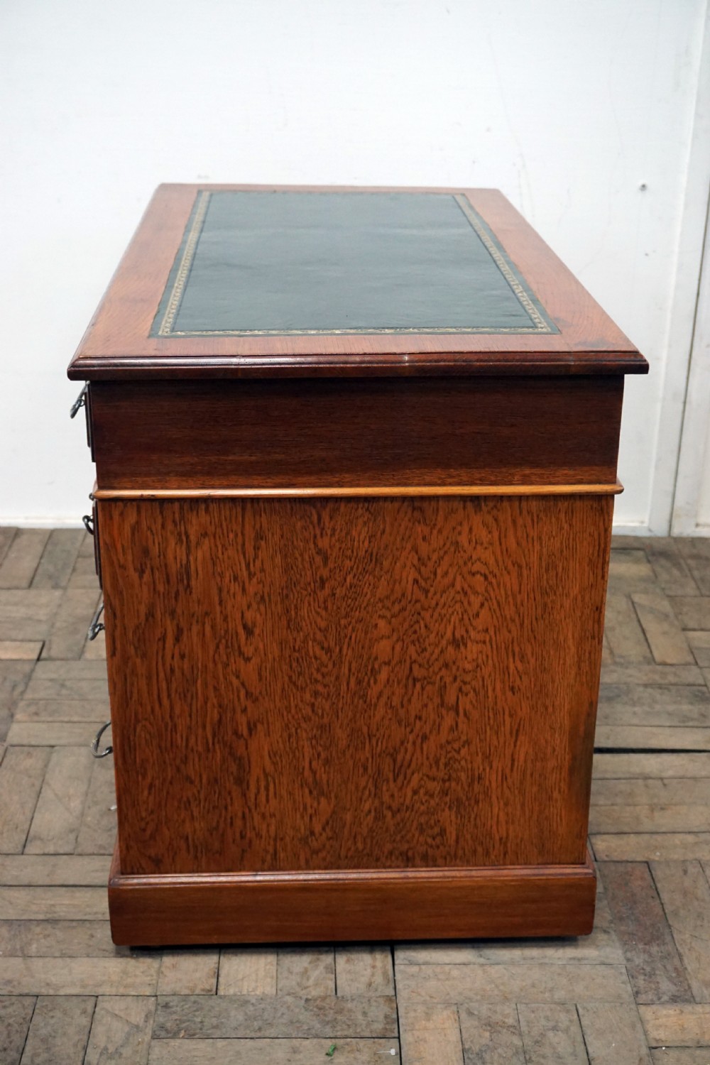 A small clean oak pedastal desk with 9 drawers View VI